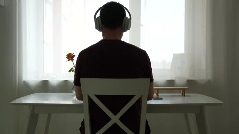 Man with Headphones Using Laptop and Phone at Desk Minimal Workspace Vídeos de archivo 332396989