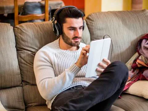 Man with headphones using tablet PC Stock Photos