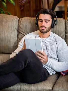 Man with headphones using tablet PC Stock Photos