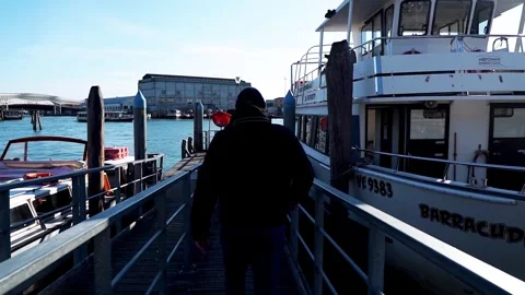 A man heads to a ship that is sailing to Venice in Italy Stock Footage 262425660