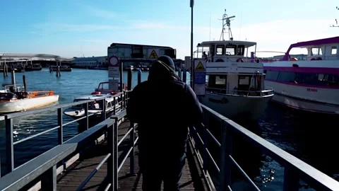 A man heads to a ship that is sailing to Venice in Italy Stock Footage 262425661