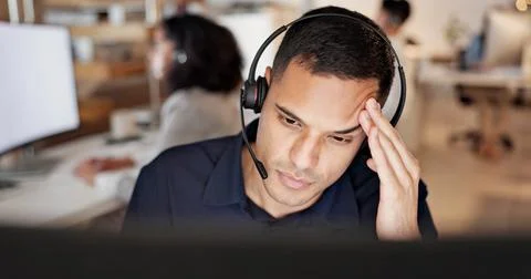 Man, headset and headache with computer at call center, stress and burnout at Stock Photos