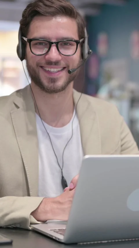 Man with Headset and Laptop Smiling at Camera, Vertical Video Stock Footage 342005301