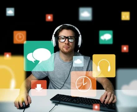 Man in headset with computer and icons on screen Stock Photos