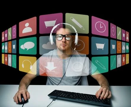Man in headset with computer and icons on screen Stockfoto's