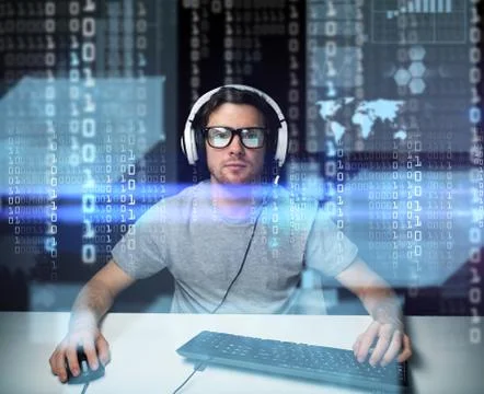 Man in headset hacking computer or programming 写真素材