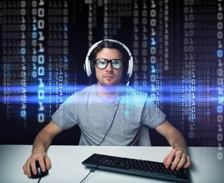 Man in headset hacking computer or programming Foto stock