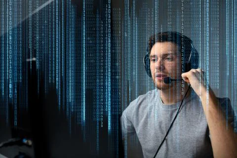 Man in headset playing computer video game at home Stock Photos