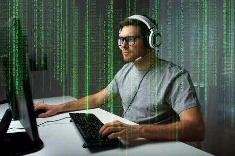 Man in headset playing computer video game at home Stock Photos