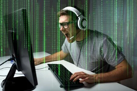 Man in headset playing computer video game at home Photos