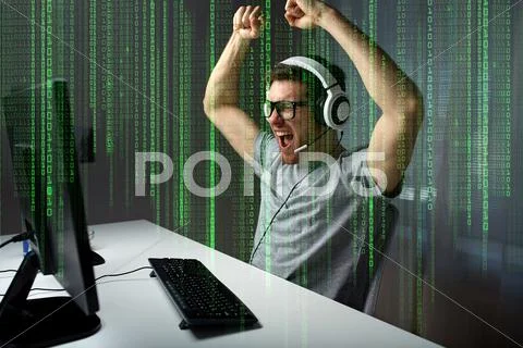 Man In Headset Playing Computer Video Game At Home