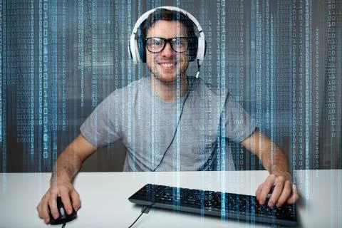 Man in headset playing computer video game at home Stock Photos