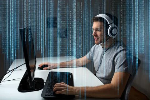 Man in headset playing computer video game at home Stock Photos