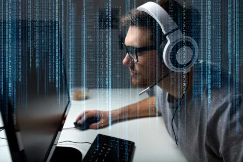 Man in headset playing computer video game at home Photos