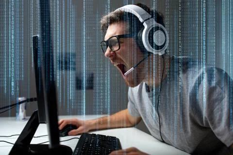 Man in headset playing computer video game at home Stock Photos