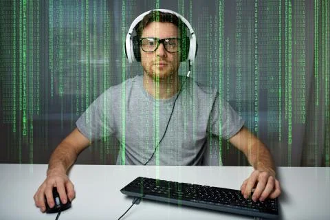 Man in headset playing computer video game at home Photos