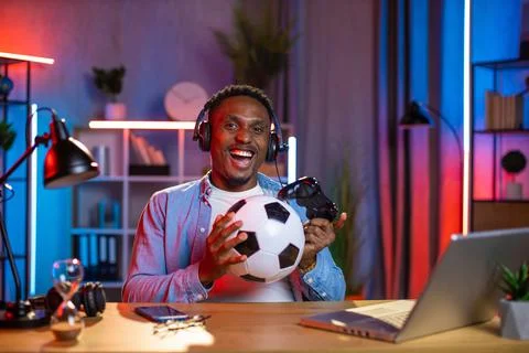 Man in headset using joystick and laptop for playing games Stock-Fotos