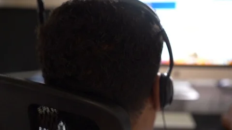 Man with headset working on computer Stock Footage 107325815