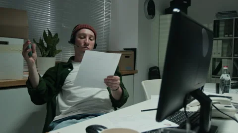 Man with Headset Working in Customer Support Reviewing Documents Stock Footage 346885577
