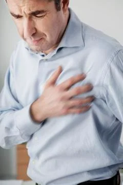 Man with heart attack Stock Photos