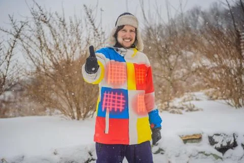 A man in a heated winter jacket. Under the jacket heating elements Stock Photos