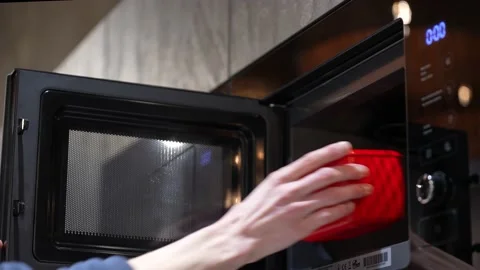 Man heating up food in the microwave Stock Footage 234821186