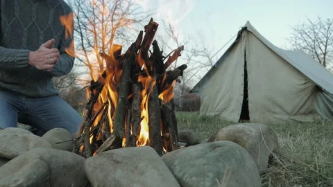 Man heats his hands in front of an open fire Stock-Footage 144814701