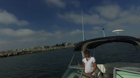 Man at the helm of a yacht Stock Footage 66183180