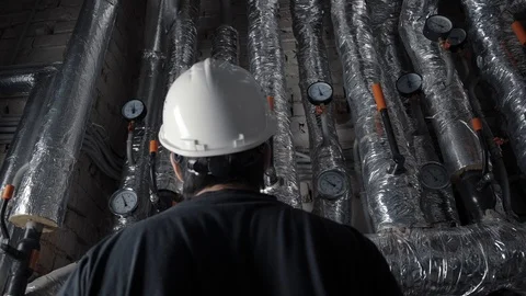 Man in helmet checking heating, ventilation system 스톡 동영상 102372902