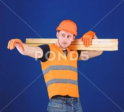 Man in helmet, hard hat and protective gloves pointing direction, blue Stock Photos