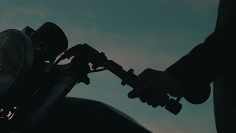 A man in a helmet sit behind a motorcycle Stock Footage 141987526