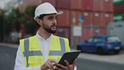 Man in helmet using tablet for work at cargo harbor Stock-Footage 166905106