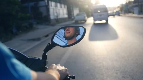 The man in the helmet will be reflected in the mirror of the motorcycle, which Stock Footage 88264262
