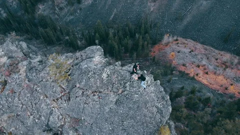 Man helping another man up on Peak of Mountain Video stock 292022509