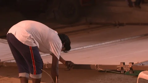 A man helping in construction at night- Shot on Sony FS7 Stock-Footage 90890698
