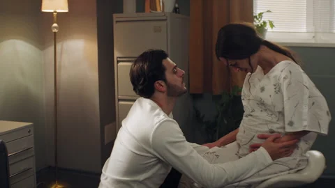 Man helping his wife while she is in pain right before childbirth Stock Footage 283069046