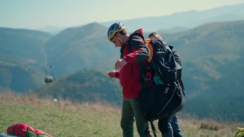 Man helping paragliding pilot to prepare for flight. Stock-Footage 201685857