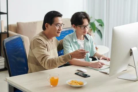 Man Helping Son with Doing Homework Stock Photos