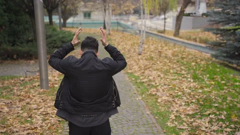 The man with helpless and psychological problems is walking outdoors. Video stock 223881644