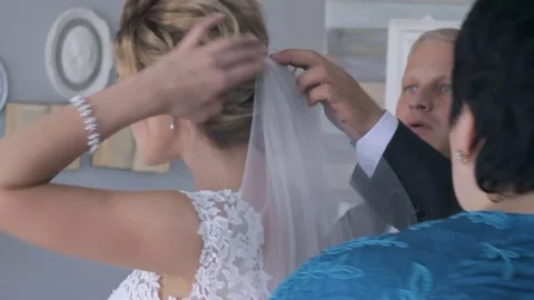 Man helps fix the bride's veil Stock Footage 76489603