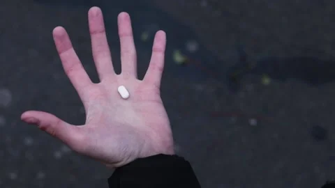 The man is hesitantly going to take a pill with medicine Stock Footage 156394151