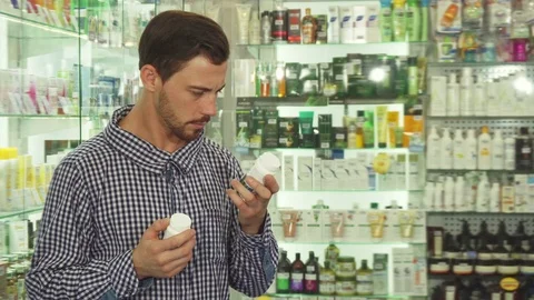 Man hesitating between two drugs Stock Footage 79933283