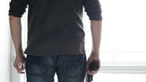 Man hide the gun Video stock 82530582