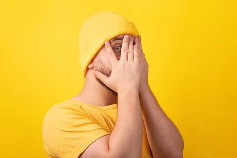 Man hides face with hands Stock Photos
