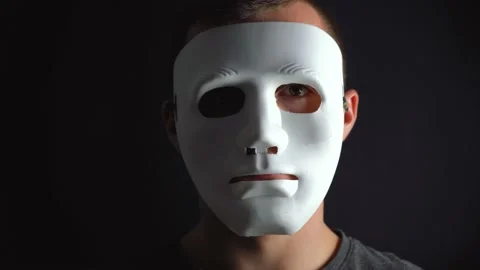 A man hides his face under a white mask 스톡 동영상 145984731
