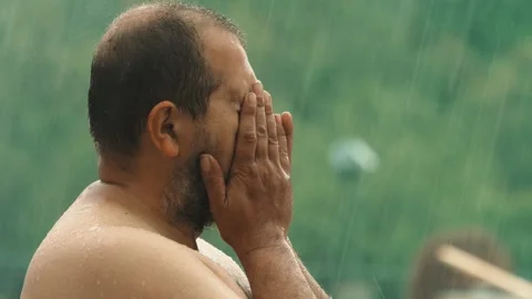 Man hides his face under the storm, shielding his soul with his hands Stock Footage 308019178