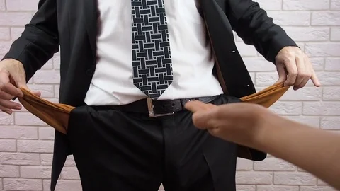 A man hides money. Shows empty pockets. Stock Footage 85236994