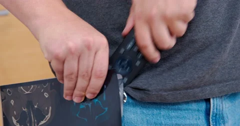 Man hides remote in pants pocket ban on watching TV, parenting, screen Addiction Stock Footage 219370849