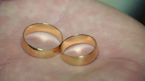 The man hides two wedding rings of the bride and groom in his fist Stock Footage 238020660