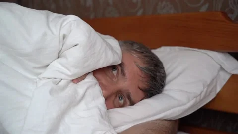 A man hides under a blanket. The concept of fear. Stock Footage 156846541